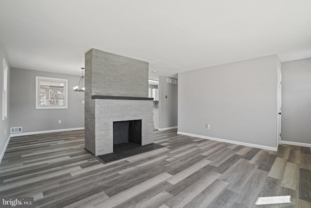 unfurnished living room featuring dark wood-style floors, a fireplace, and baseboards