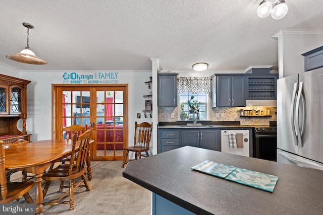 kitchen with electric range, dishwasher, dark countertops, freestanding refrigerator, and a sink