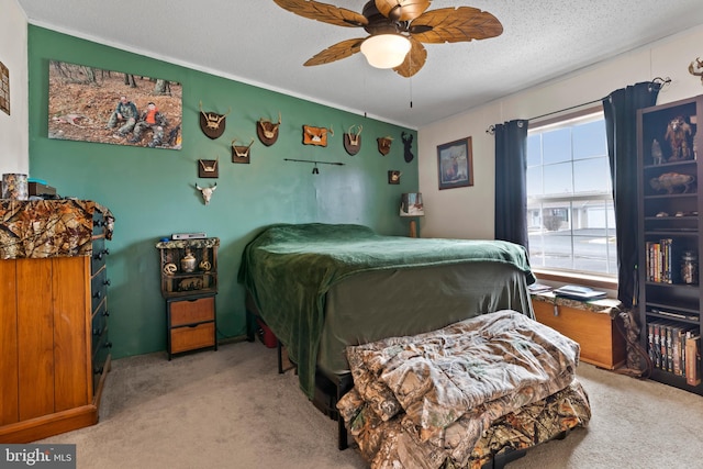 bedroom with a textured ceiling, ceiling fan, and light colored carpet