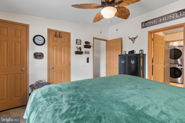 bedroom with ceiling fan and stacked washer / drying machine