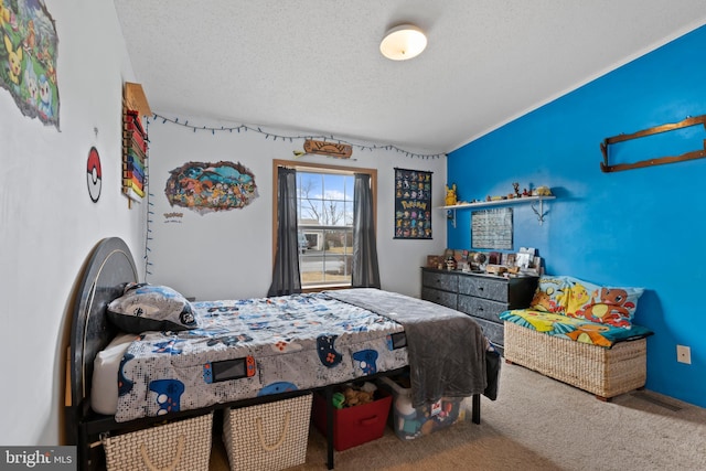 carpeted bedroom featuring a textured ceiling and visible vents