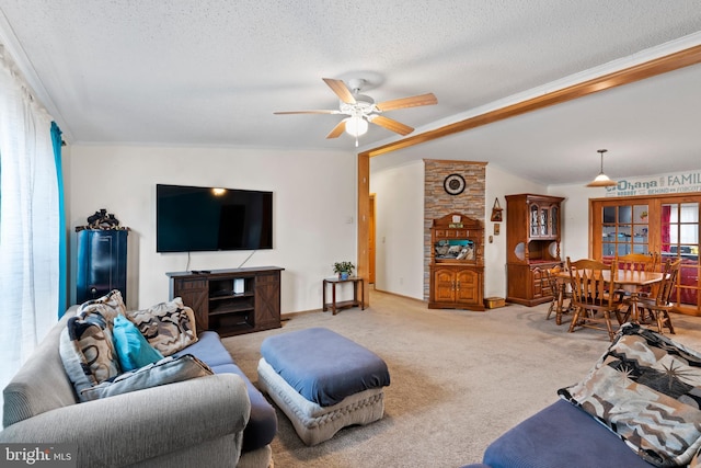 living room featuring light carpet, ceiling fan, a textured ceiling, and baseboards