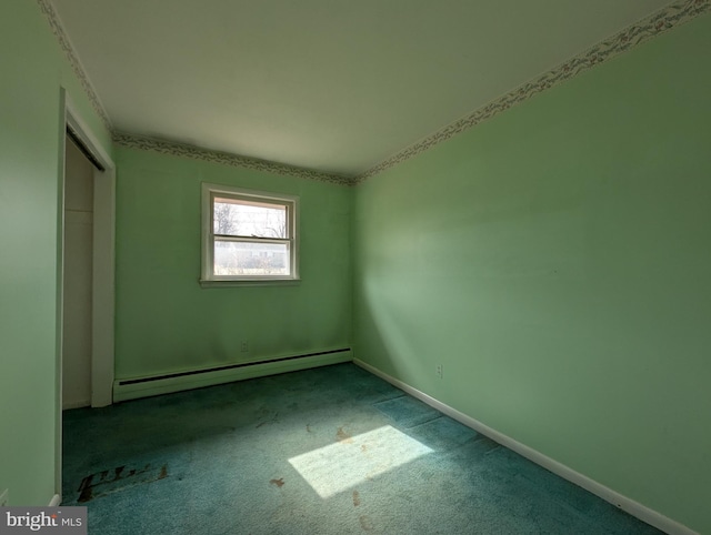 empty room featuring light carpet, baseboards, and baseboard heating