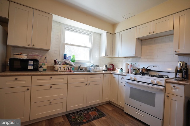 kitchen featuring white cabinetry, dark wood finished floors, backsplash, and white gas range oven