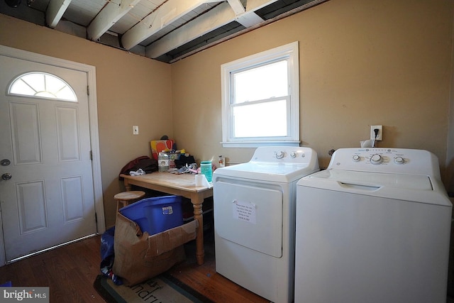 clothes washing area featuring laundry area, dark wood finished floors, and washing machine and clothes dryer