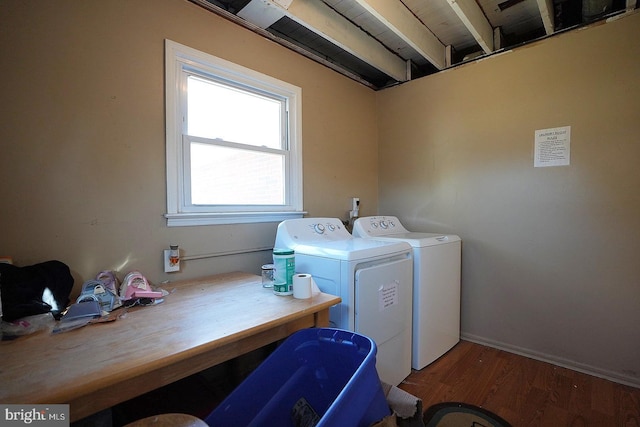 laundry room with washing machine and dryer, laundry area, and wood finished floors