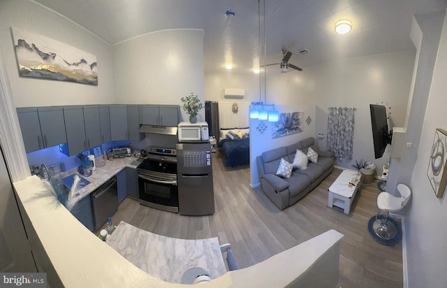 kitchen with stainless steel electric stove, light countertops, white microwave, dishwasher, and under cabinet range hood