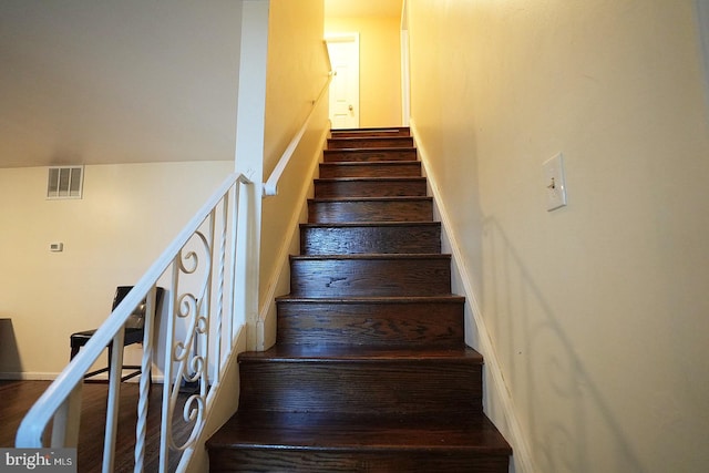 stairs featuring visible vents and wood finished floors