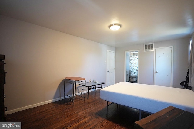 interior space featuring dark wood-type flooring, visible vents, and baseboards