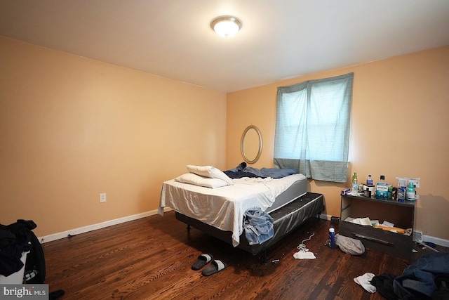 bedroom with dark wood-style flooring and baseboards