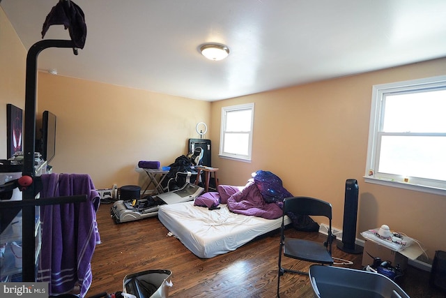 bedroom featuring dark wood finished floors and baseboards