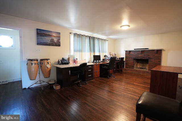 office space with dark wood-style floors and a fireplace