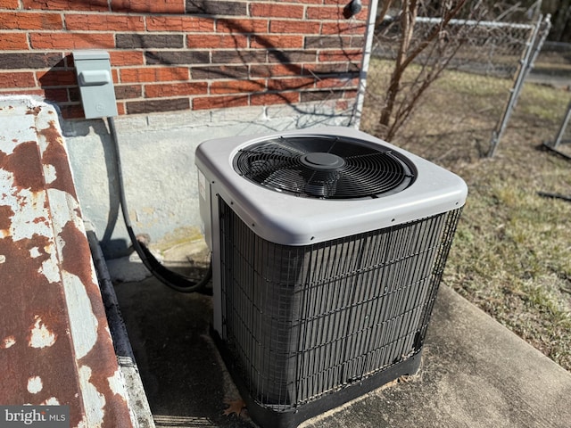 exterior details with central AC and brick siding