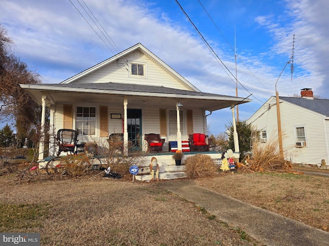 view of front of house featuring a front yard and a porch