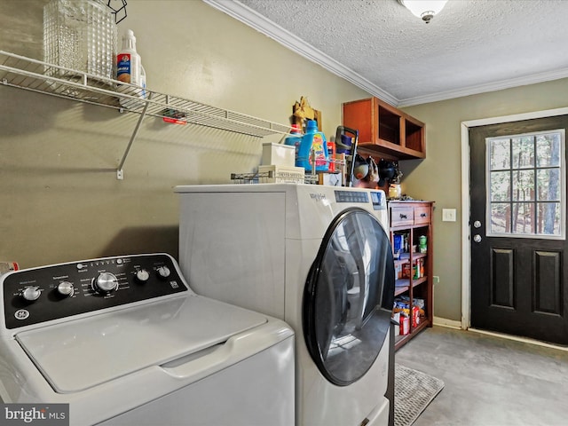 clothes washing area with laundry area, ornamental molding, washer and clothes dryer, and a textured ceiling