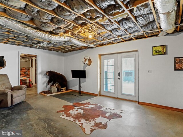 basement with french doors and baseboards