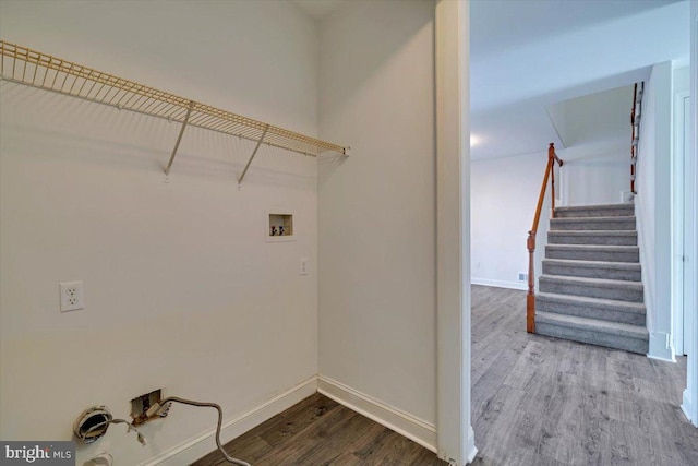 washroom with washer hookup, laundry area, baseboards, and wood finished floors