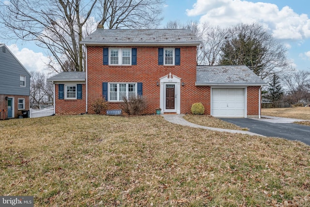 view of front of house with a front lawn and a garage