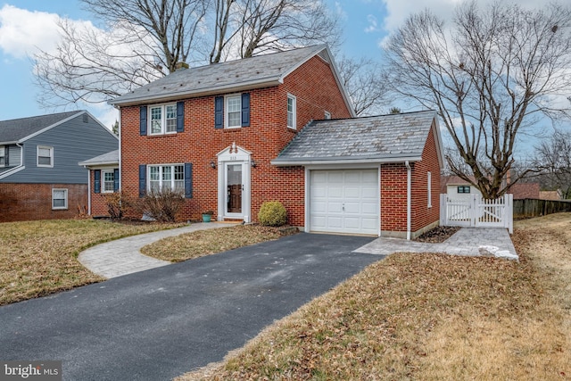 view of front of home with a front yard and a garage