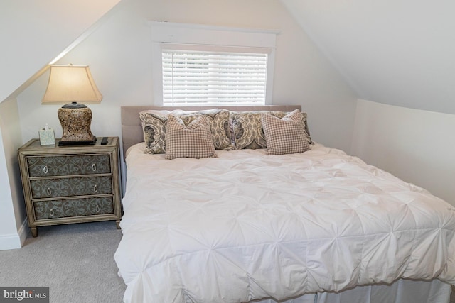 bedroom with vaulted ceiling and carpet floors