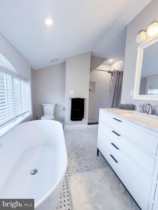 full bath with vanity, a shower with curtain, a freestanding tub, toilet, and visible vents