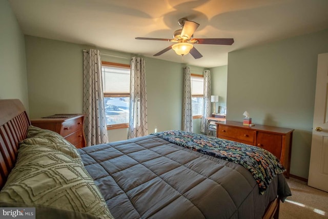 bedroom featuring light colored carpet and ceiling fan