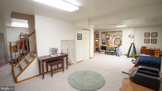 living area with stairs, baseboards, and carpet