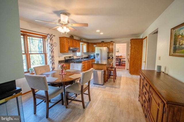 dining room featuring recessed lighting, light wood-style floors, and a ceiling fan