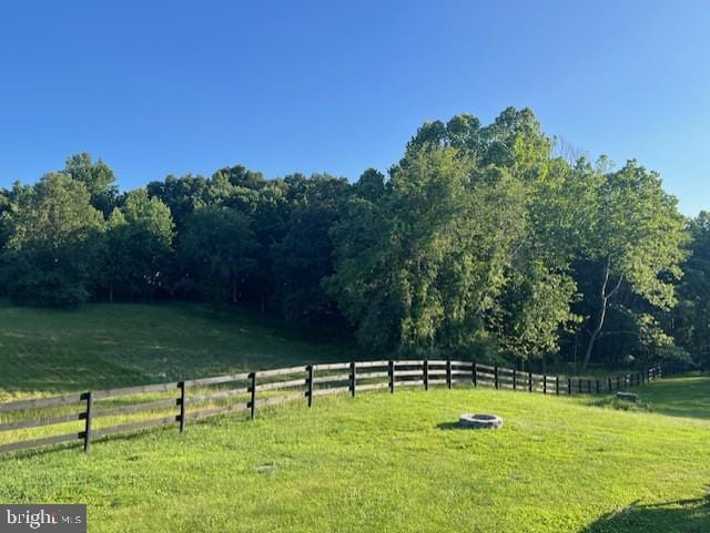 view of yard featuring a rural view and fence