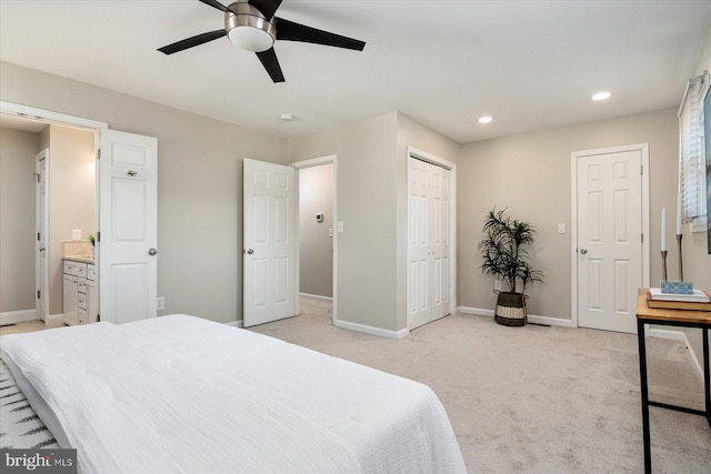 bedroom with ceiling fan, light carpet, baseboards, recessed lighting, and ensuite bath