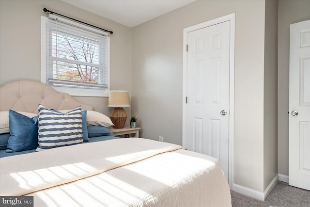 bedroom featuring carpet and baseboards