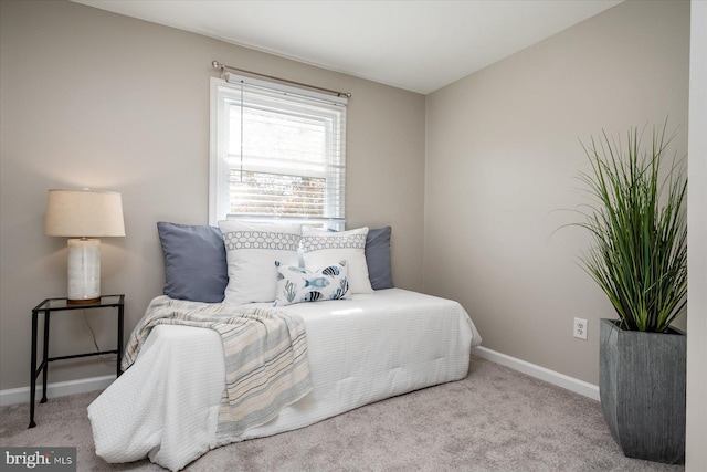 bedroom featuring light carpet and baseboards