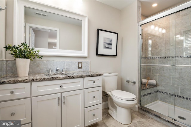 full bath with toilet, a stall shower, vanity, and visible vents