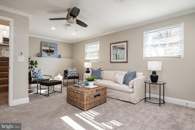 living area with ornamental molding, light carpet, baseboards, and stairs