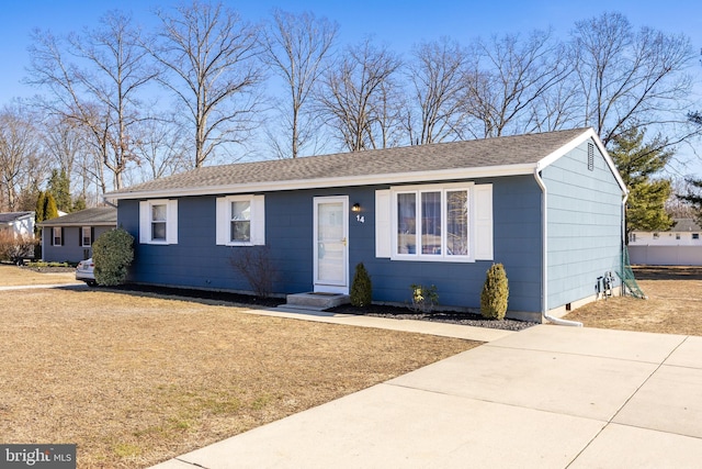 ranch-style home featuring roof with shingles