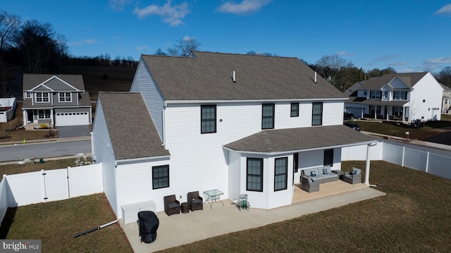 back of property with an outdoor hangout area, a patio area, roof with shingles, and a fenced backyard