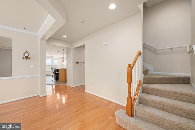 stairway with recessed lighting, baseboards, and wood finished floors