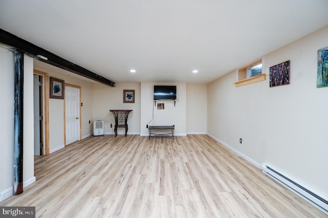 finished below grade area with baseboards, recessed lighting, light wood-style floors, and a baseboard heating unit