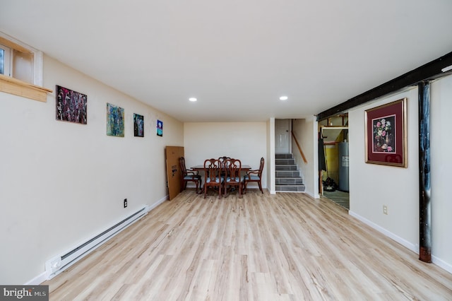 interior space featuring a baseboard radiator, stairway, baseboards, light wood-type flooring, and electric water heater