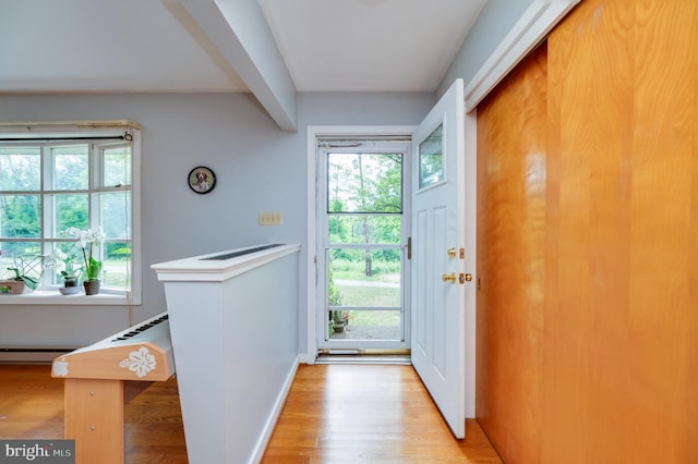 entryway featuring baseboards, a baseboard radiator, and light wood-style floors