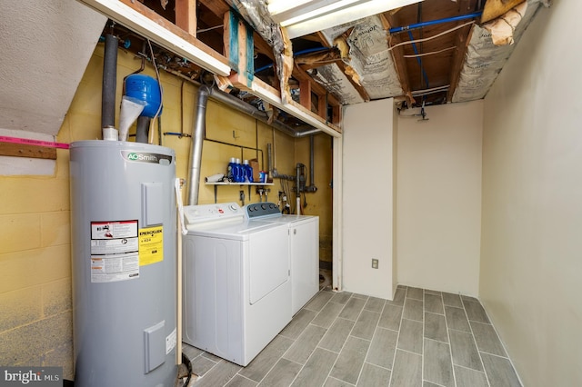 laundry area featuring water heater and washing machine and dryer