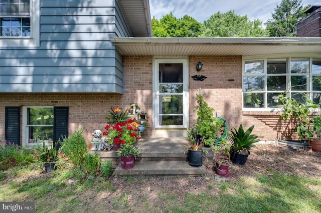 property entrance with brick siding