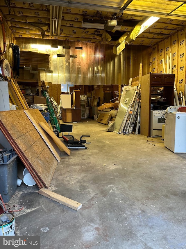 garage with washer / clothes dryer and a garage door opener