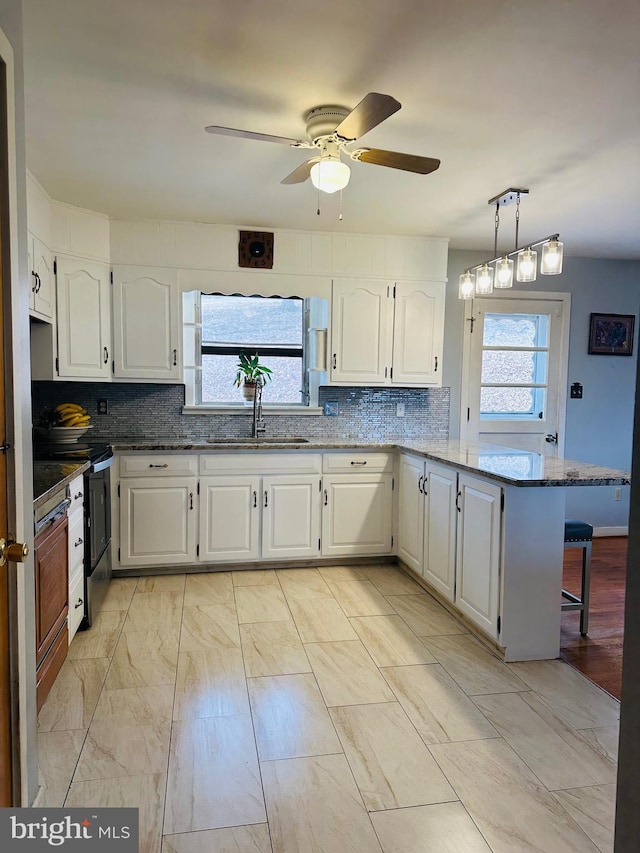 kitchen with white cabinetry and a peninsula