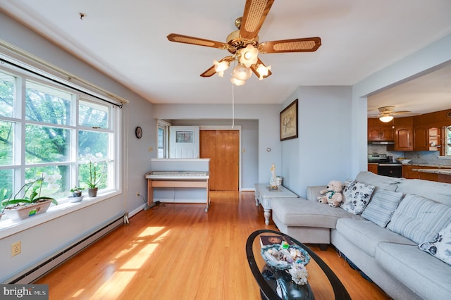 living area featuring baseboards, baseboard heating, and light wood-style floors