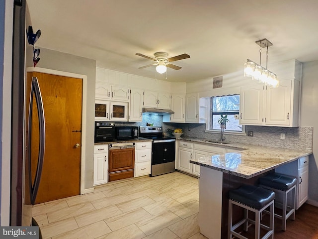 kitchen featuring under cabinet range hood, stainless steel electric stove, pendant lighting, white cabinets, and a peninsula