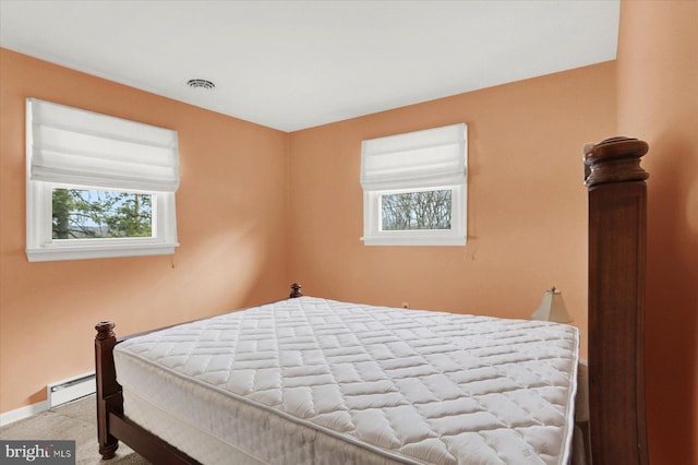 bedroom with baseboards, visible vents, baseboard heating, and carpet floors