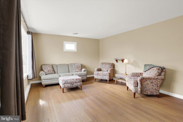 living room with baseboards and wood finished floors