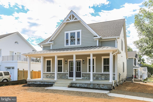 view of front of property with covered porch and a garage