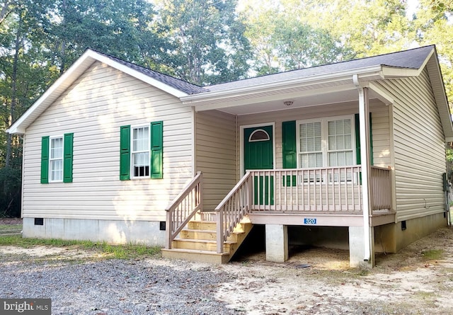 view of front of home featuring a porch, crawl space, and a shingled roof